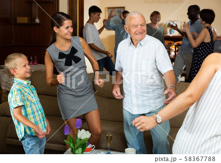 Adults and children dancing at a party at home Adults and children dancing at a party at home 58367788