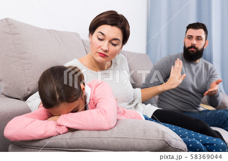 Father lecturing wife and daughter Father lecturing wife and daughter 58369044