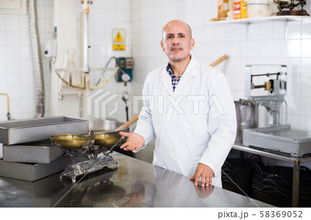Adult male standing in production workshop 58369052