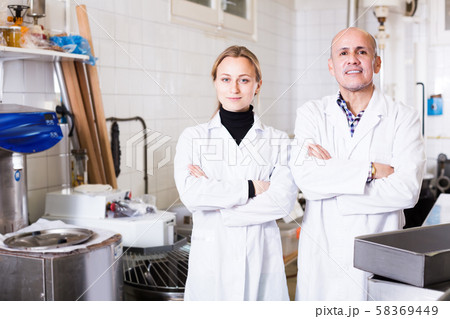 Different aged people standing in production workshop 58369449