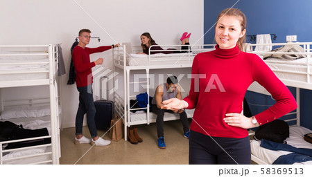 Hostess of hostel showing bedroom Hostess of hostel showing bedroom 58369513
