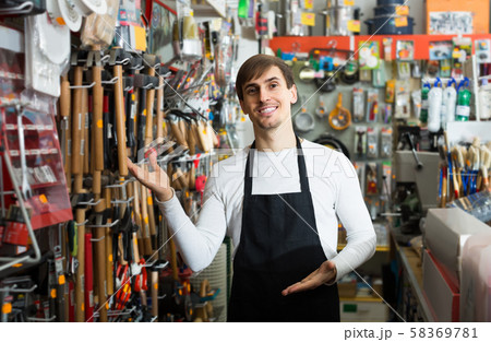 male seller posing at tooling section of household store 58369781