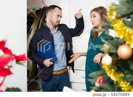 Debt collector and woman at doorway Debt collector and woman at doorway 58370004