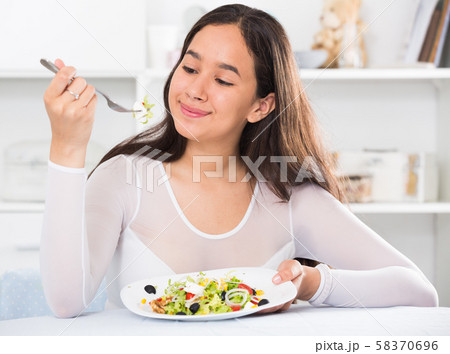 young woman eating freshness salad young woman eating freshness salad 58370696