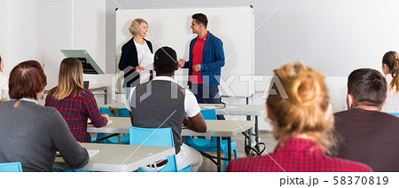Students working with professor in auditorium Students working with professor in auditorium 58370819