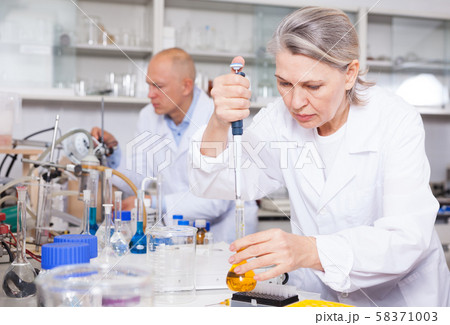 Female scientist working with reagents 58371003
