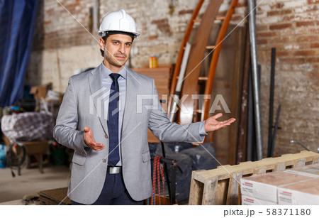 Friendly man at construction site 58371180