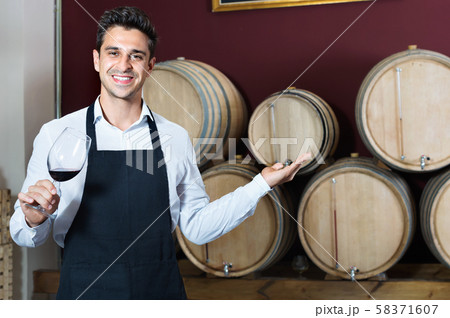 Man having glass with wine sample in alcohol section Man having glass with wine sample in alcohol section 58371607