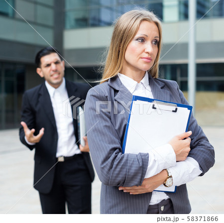 Female employee is upset with the reprimand of boss Female employee is upset with the reprimand of boss 58371866