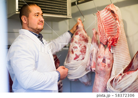 staff selling halal meat staff selling halal meat 58372306