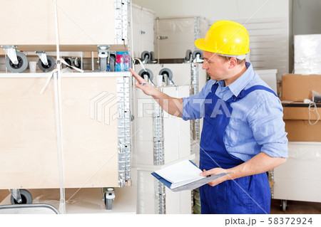 Foreman checking materials and tools Foreman checking materials and tools 58372924