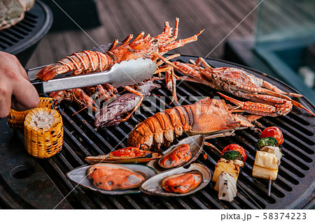Lobster and mix seafood barbecue cokking on grill 58374223
