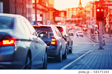 Cars moving on the road in city in late evening 58375164