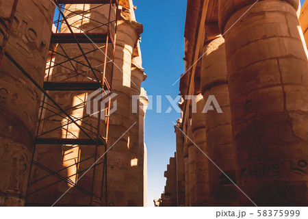 Columns in Karnak Temple Complex, famous architectural landmark in Luxor, Egypt. Pillars of the Great Hypostyle Hall from the Precinct of Amun-Re. 58375999