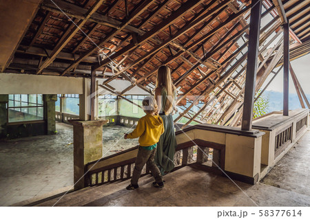 mother and son tourists in abandoned and mysterious hotel in Bedugul. Indonesia, Bali Island. Bali 58377614