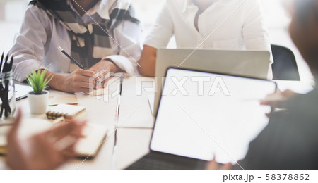 A group of young business people consulting their A group of young business people consulting their 58378862
