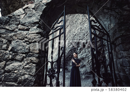 Girls in a black dress with a white collar that 58380402