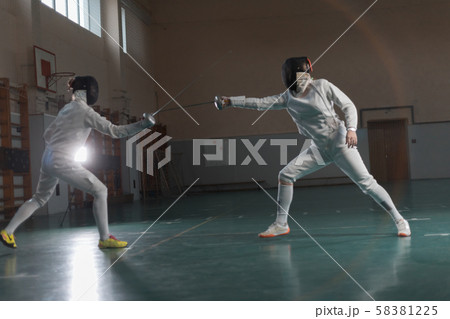 A portrait of two young women fighting with swords A portrait of two young women fighting with swords 58381225