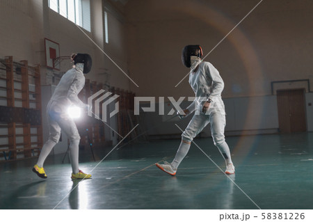 A portrait of two young women fencers in the hemlets training 58381226