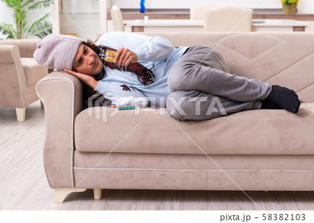 Young man suffering from flu at home 58382103