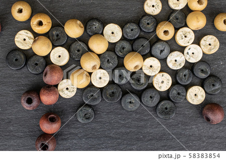 Colorful wooden bead on grey stone Colorful wooden bead on grey stone 58383854