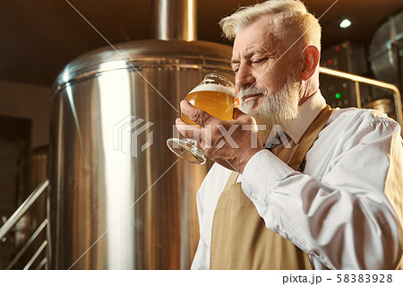 Brewery expert tasting cold large beer with foam. Brewery expert tasting cold large beer with foam. 58383928