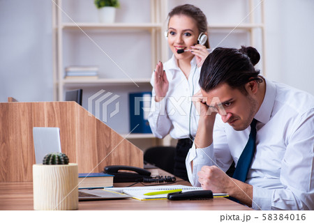 Call center operators working in the office Call center operators working in the office 58384016