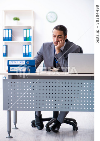 Young male accountant working in the office 58384499