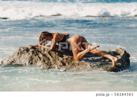 Attractive young woman, model in bikini at tropical beach. 58384565