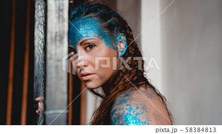 Portrait of beautiful woman with sparkles on her face. Girl with art make up 58384813