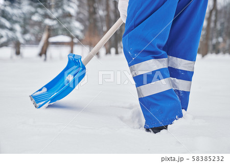 Worker of city service in process of removing snow 58385232