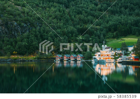 Flam, Norway. Famous Red Wooden Docks In Summer Evening. Small Tourist Town Of Flam On Western Side Flam, Norway. Famous Red Wooden Docks In Summer Evening. Small Tourist Town Of Flam On Western Side 58385539