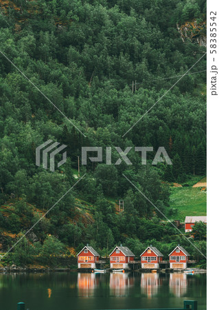 Flam, Norway. Famous Red Wooden Docks In Summer Evening. Small Tourist Town Of Flam On Western Side Flam, Norway. Famous Red Wooden Docks In Summer Evening. Small Tourist Town Of Flam On Western Side 58385542