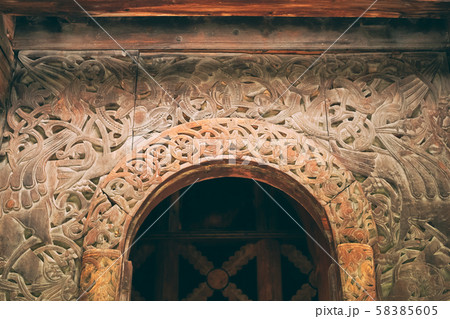 Borgund, Norway. Carved Details Of Famous Wooden Norwegian Landmark Stavkirke. Ancient Old Wooden Borgund, Norway. Carved Details Of Famous Wooden Norwegian Landmark Stavkirke. Ancient Old Wooden 58385605