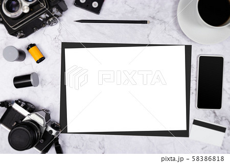 flat lay vintage camera on white marble background with white blank paper and photography tool 58386818
