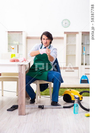 Young businessman cleaning the house Young businessman cleaning the house 58387788