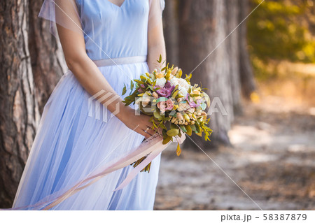 bridal bouquet of roses in the the bride's hands bridal bouquet of roses in the the bride's hands 58387879