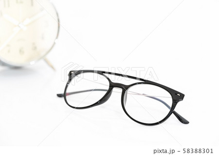 Eye glasses with alarm clock on white 58388301