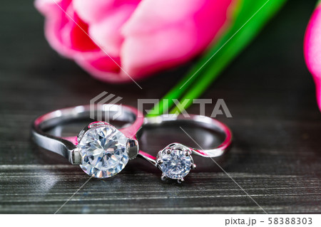 Diamond wedding rings with tulip flower on black 58388303