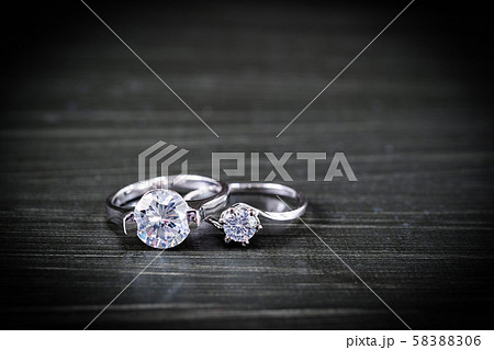 Diamond wedding rings on black background 58388306