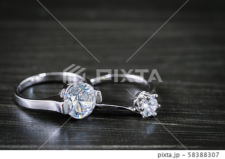 Diamond wedding rings on black background 58388307