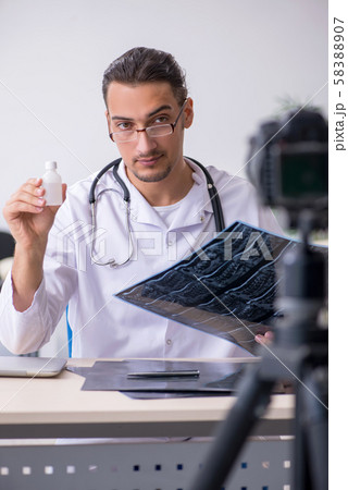 Young male doctor radiologist recording video for his blog 58388907