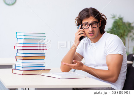 Young male student sitting in the classroom Young male student sitting in the classroom 58389902