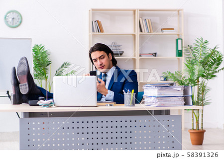 Young businessman sitting and working in the office 58391326