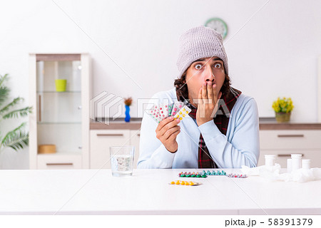 Young man suffering from flu at home Young man suffering from flu at home 58391379