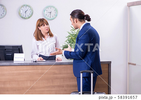 Young businessman at hotel reception 58391657