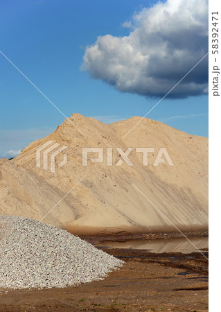Mountains of sand and stone against a blue sky 58392471