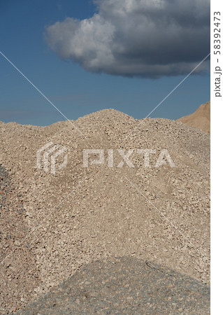 Mountains of sand and stone against a blue sky 58392473