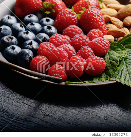 Tray with ripe organic bilberry raspberry Tray with ripe organic bilberry raspberry 58393278