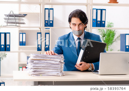 Young male employee with tape on the mouth 58393764